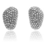 A PAIR OF DIAMOND STUD EARRINGS in gold and silver, each of irregular shape jewelled all over with