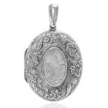 AN ANTIQUE LOCKET in sterling silver, the oval locket decorated to the front with high relief floral