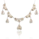 A FILIGREE NECKLACE AND BROOCH SUITE in silver, the necklace designed with five links featuring