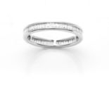 A DIAMOND ETERNITY RING in 18ct white gold, comprising a single row of baguette cut diamonds,