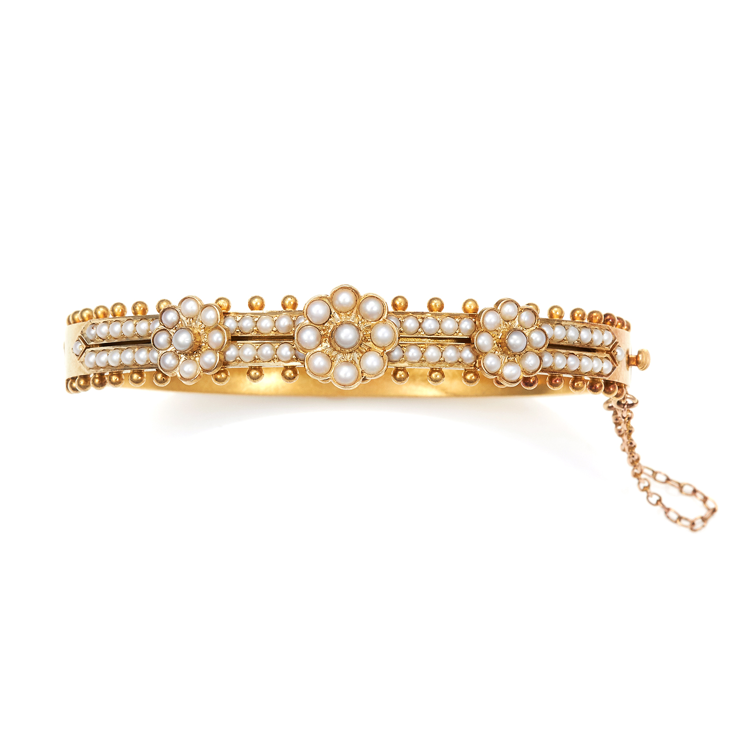 AN ANTIQUE PEARL BANGLE, 19TH CENTURY in high carat yellow gold, half jewelled with pearl cluster