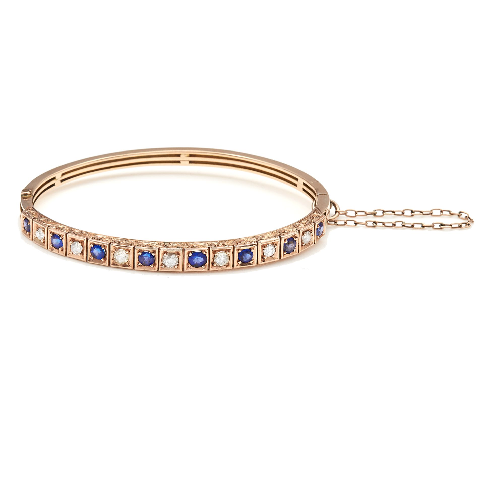 AN ANTIQUE SAPPHIRE AND DIAMOND BANGLE in 15ct yellow gold, a half hoop decorated with alternating