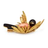 A CORAL, ONYX, EMERALD AND DIAMOND BIRD BROOCH in 18ct yellow gold, the head, body and tail formed
