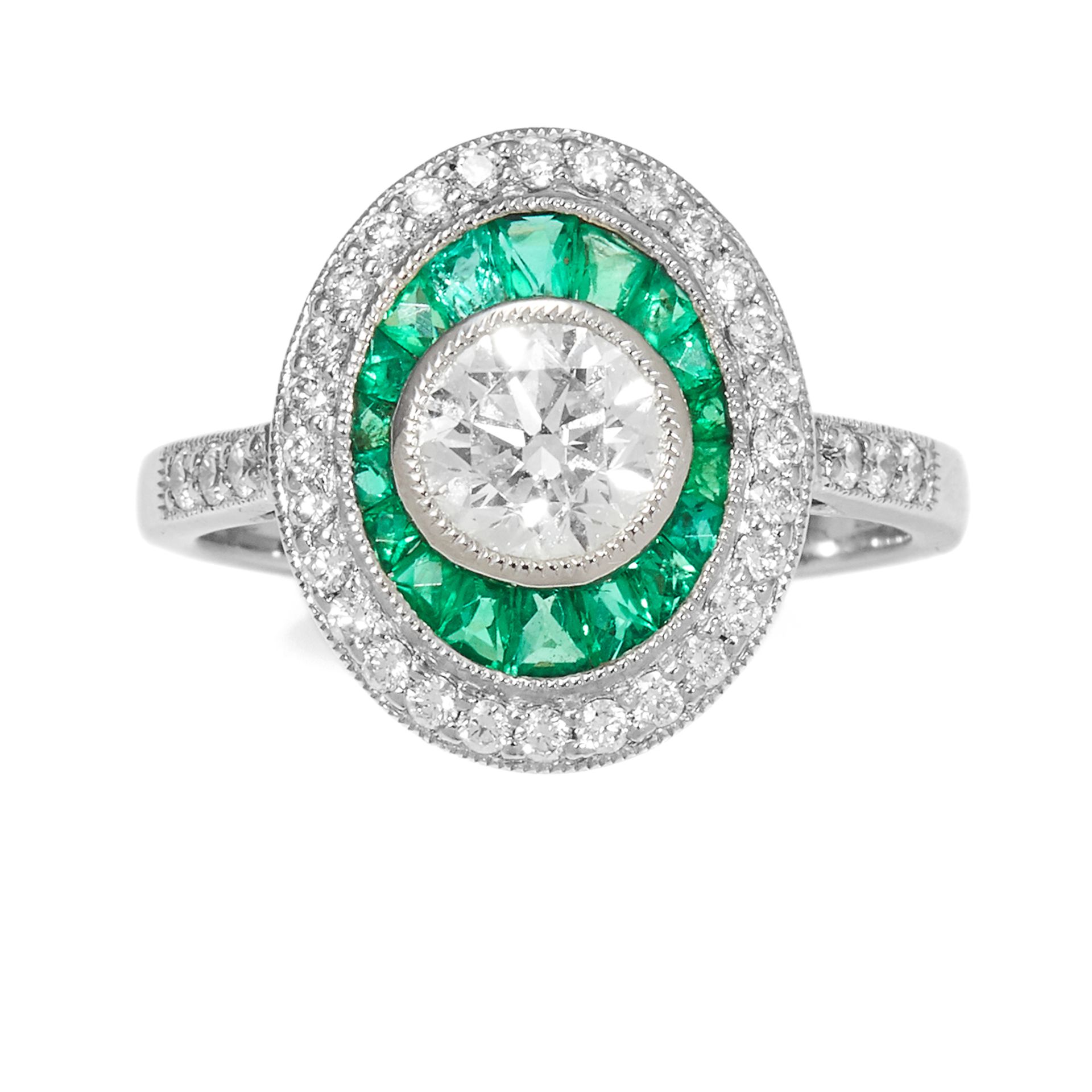 A DIAMOND AND EMERALD DRESS RING in platinum, set with a central round cut diamond of 1.0 carats