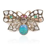 A VICTORIAN OPAL, DIAMOND, EMERALD AND RUBY BUTTERFLY BROOCH in yellow gold, set with a central