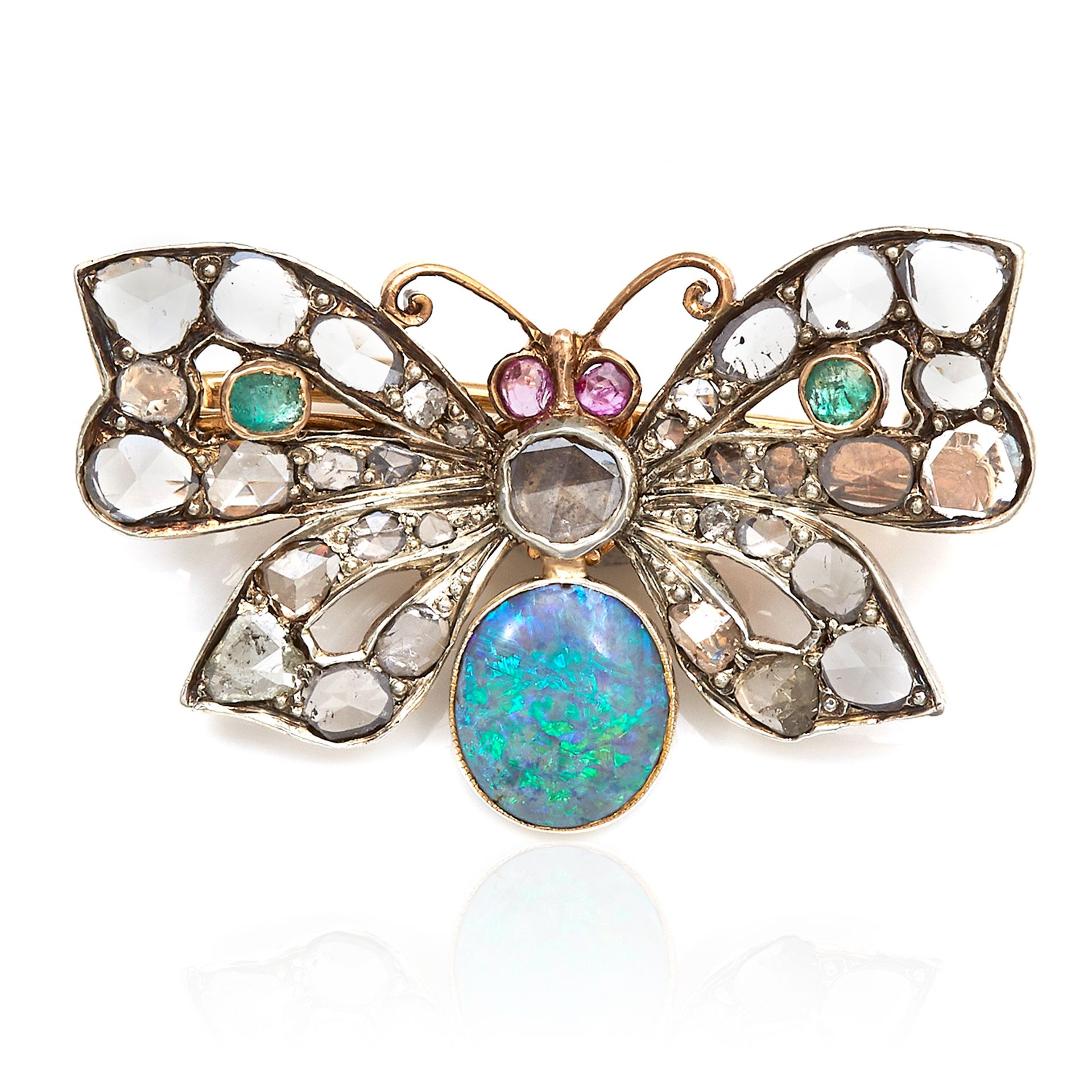 A VICTORIAN OPAL, DIAMOND, EMERALD AND RUBY BUTTERFLY BROOCH in yellow gold, set with a central