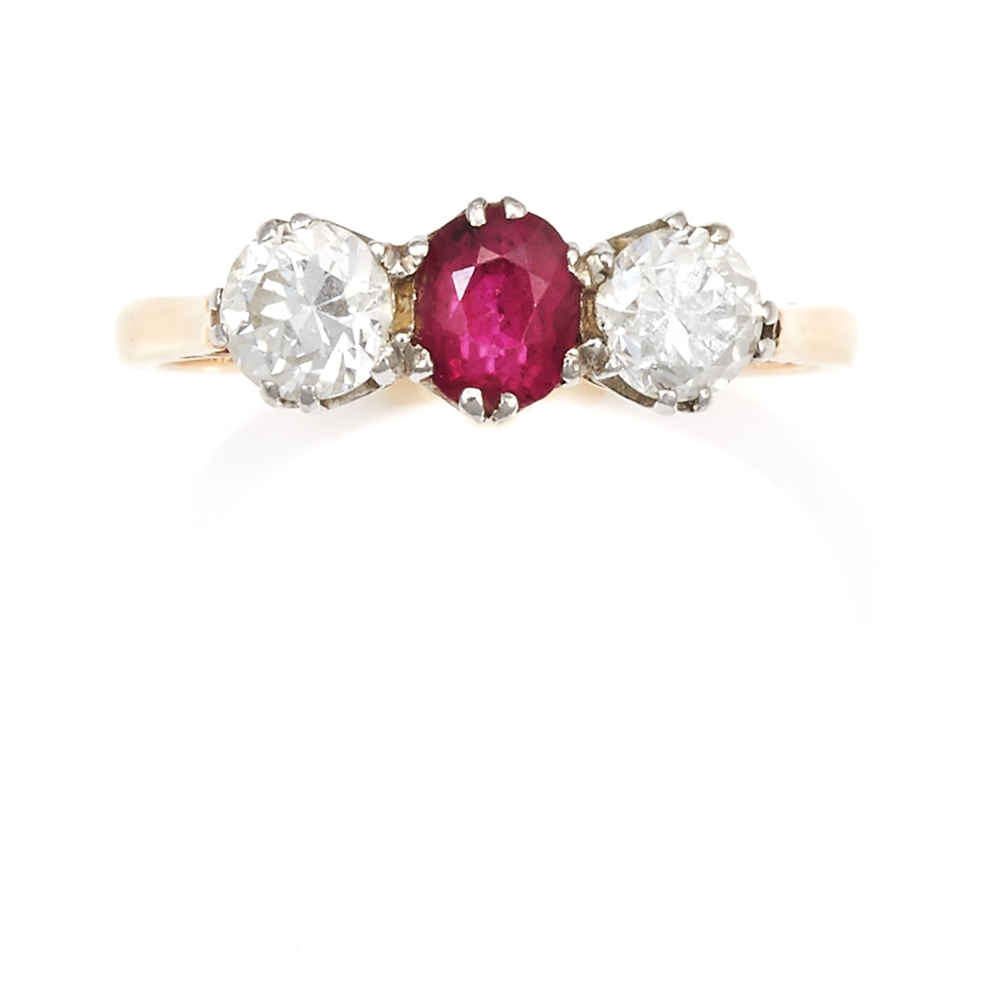 AN ANTIQUE RUBY AND DIAMOND THREE STONE RING in 18ct yellow gold and platinum, the central oval