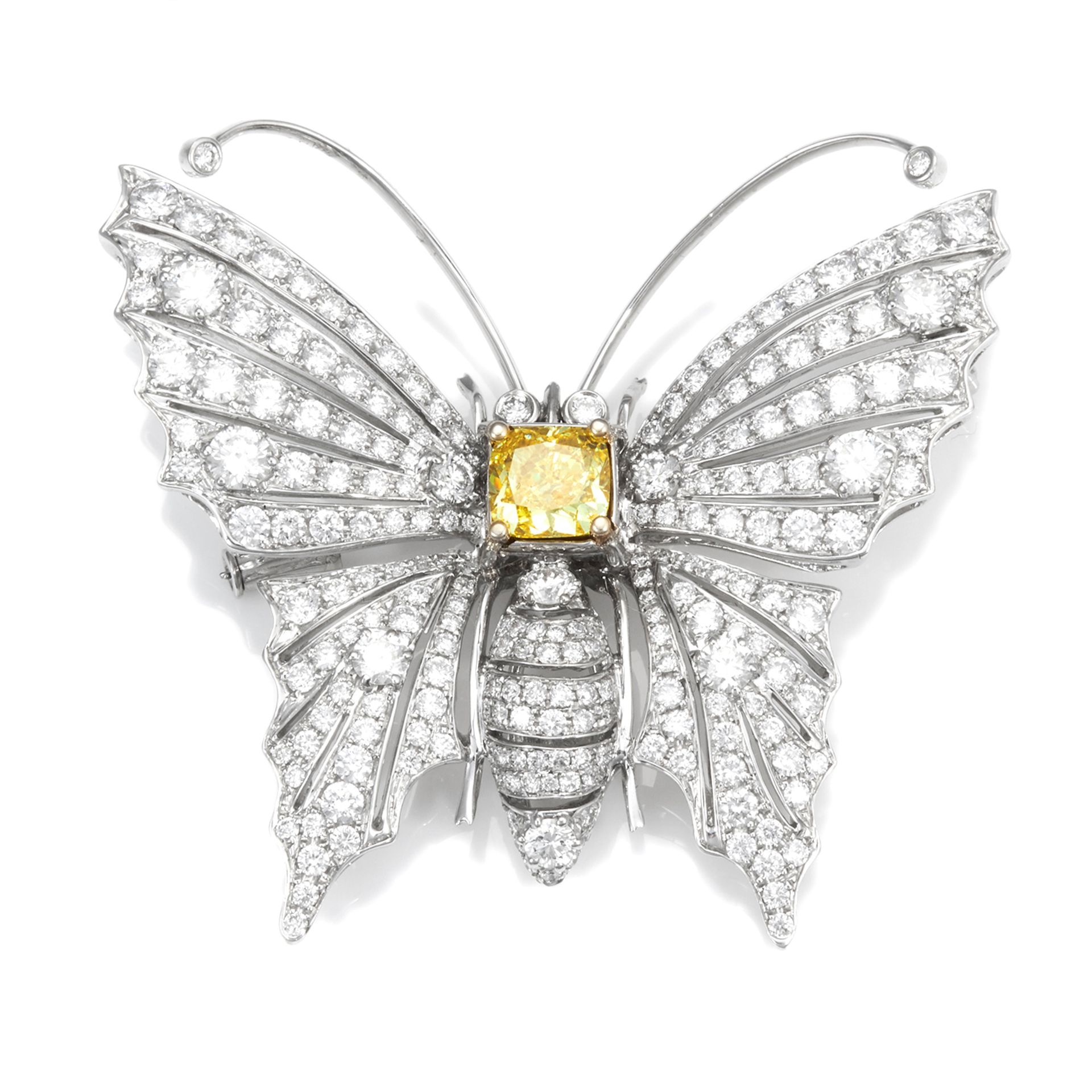 A FANCY VIVID YELLOW DIAMOND AND WHITE DIAMOND BUTTERFLY BROOCH in 18ct white gold, in the form of a