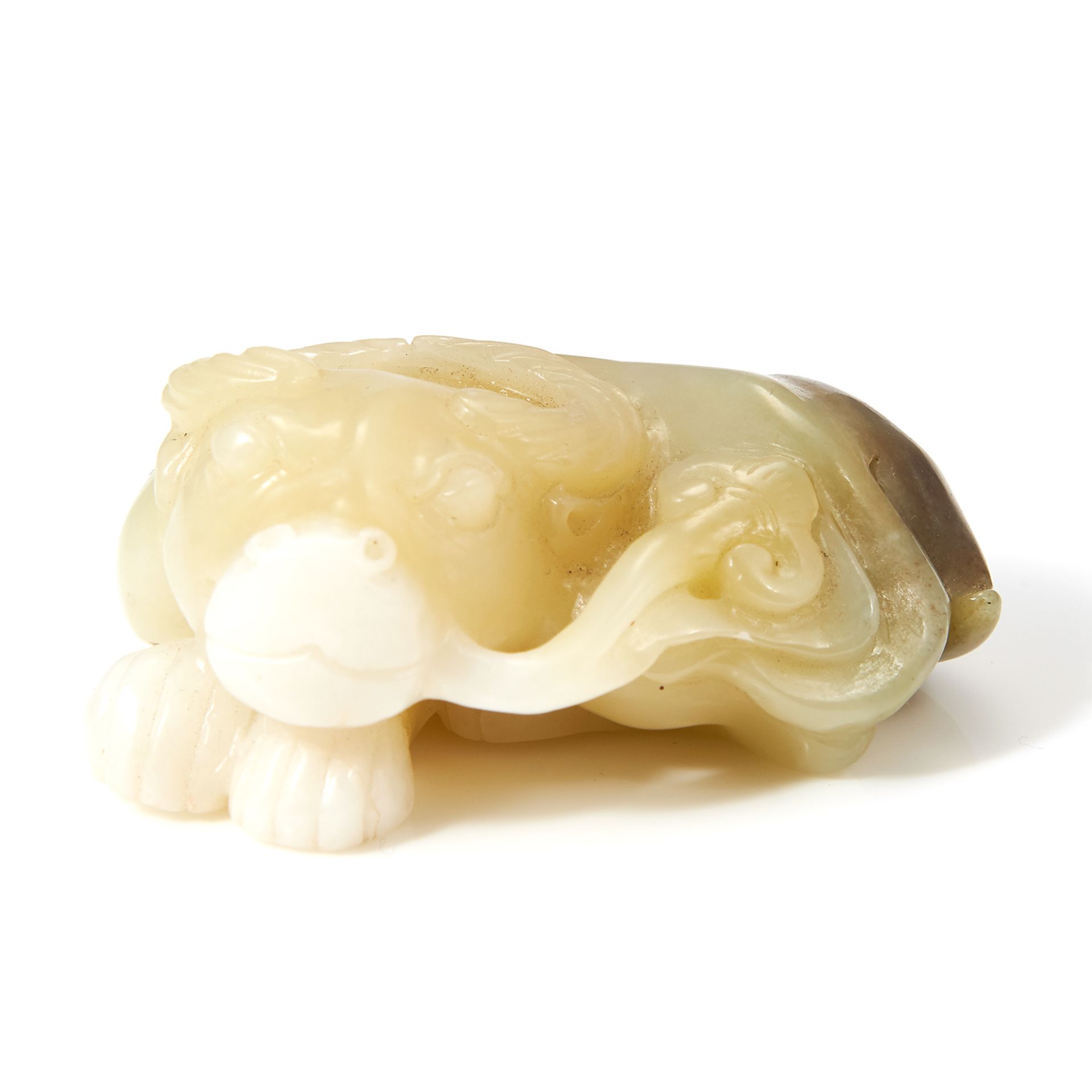 A CHINESE CARVED JADE RAM STATUE carved in detail to depict a ram, curled up and laying down, 5.8cm,