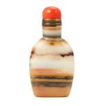 A CHINESE BANDED HARDSTONE SNUTT BOTTLE with coral cap, 7.6cm.