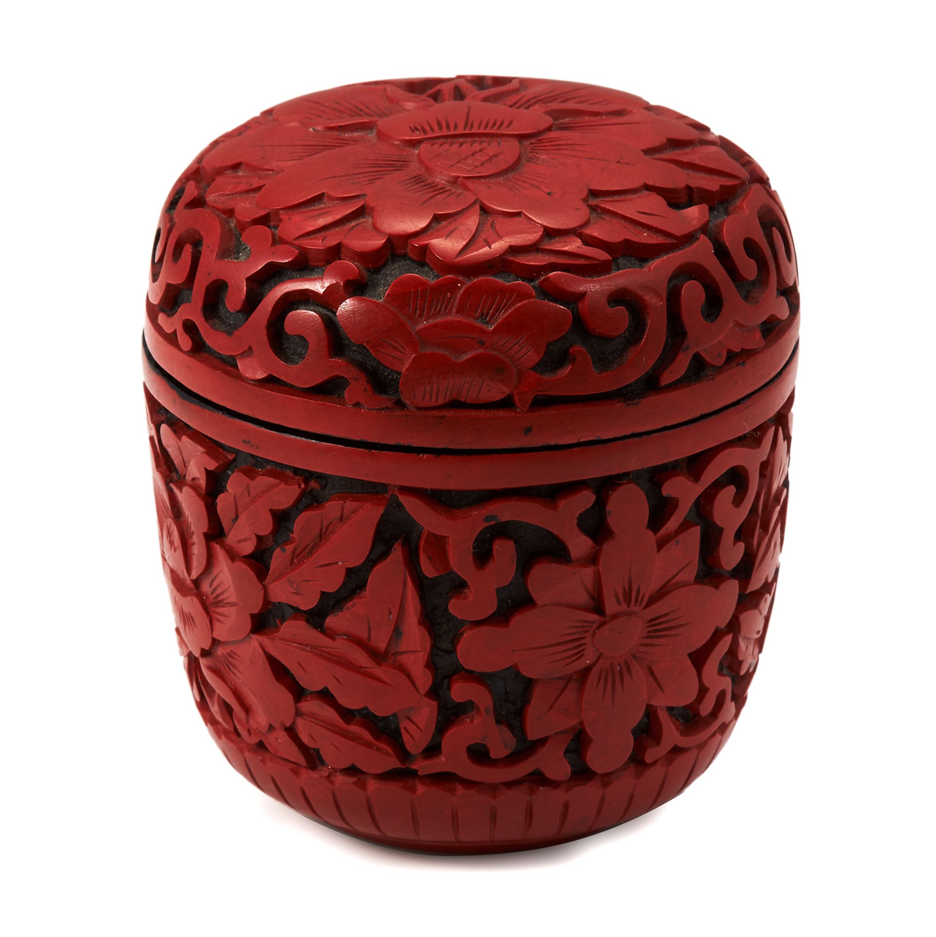 A CHINESE CARVED CINNABAR BOX of rounded form, base and lid carved with flowers, 7.2cm.