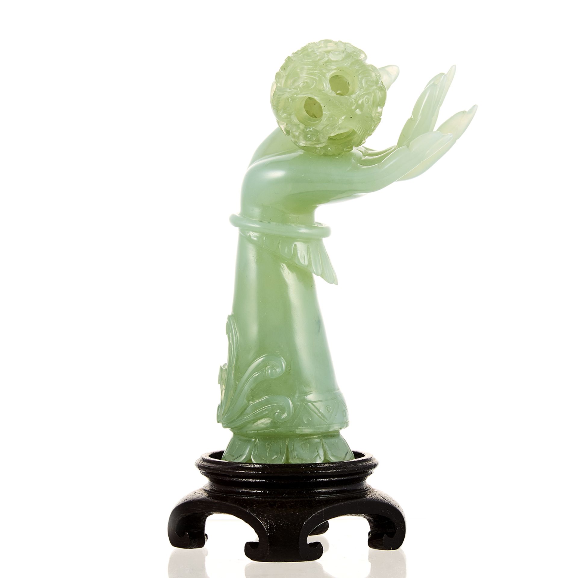 A CHINESE CARVED JADE PUZZLE BALL AND BUDDHA HAND STATUE carved in detail from jade, depicting a