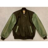 An original unworn ‘varsity’ style jacket (black with green leather arms & detailing) produced