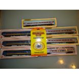 A group of American Outline coaches by BACHMANN in Amtrak, and VIA liveries together with a