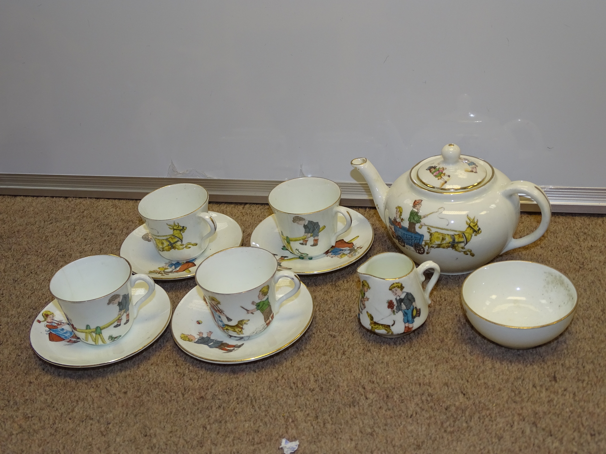 A 1930s children's play teaset - some cracks and minor damage but complete as lotted, marked "CB"