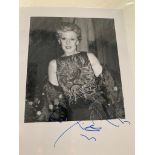 A large number of photographs presented in an album that feature personally signed autographs &