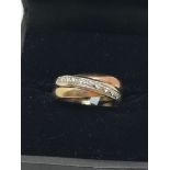 9ct triple colour gold diamond (0.08ct) crossover ring (sz I)