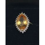 9ct gold dressing ring with oval citrine and diamond border (sz K.5)