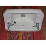 Cloaks room porcelain wash hand basin and swing mirror in the Art Deco style