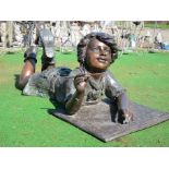 Bronze sculpture of a boy with book