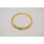 9ct non-hallmarked green stone set bangle