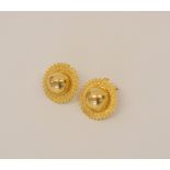 Asian gold pair of stud earrings