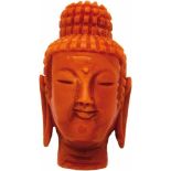 Buddha-Kopf aus KoralleFein herausgearbeiteter Buddha-Kopf aus lachsfarbener Koralle. L. 3 cm.