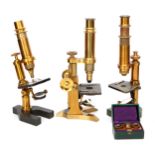 A Collection of three Cased Brass Microscopes,