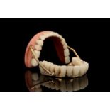 A Complete Set of Sprung Dentures in Gold & Porcelain,