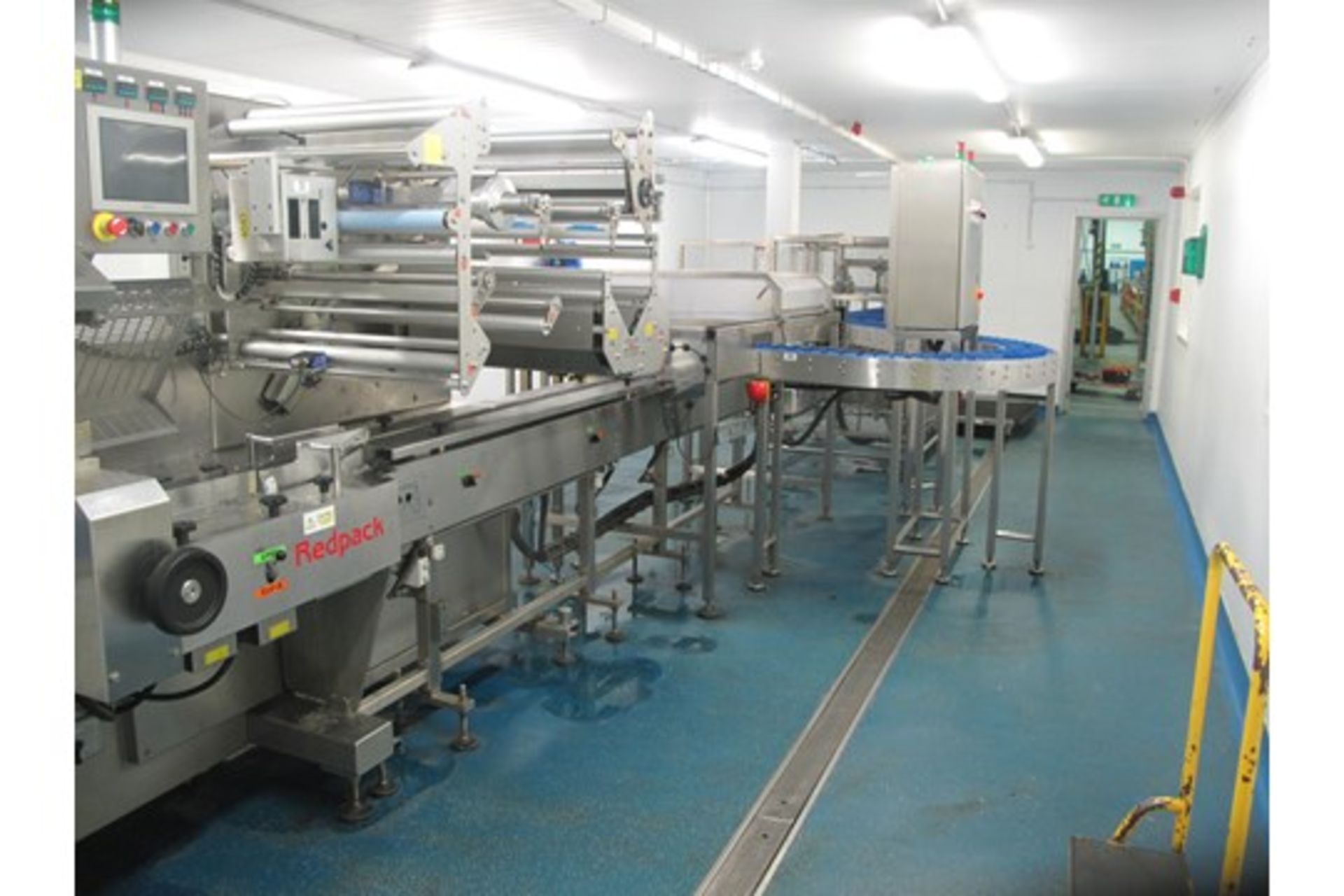 Complete cucumber cutting and packing line consists of: Redpack Flow-wrapper P325SP, twin spooling