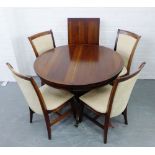 A Willis & Gambier dining suite comprising a circular topped extending table with an extra leaf
