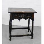 A carved dark oak carved table of small proportions, with mask head frieze and turned supports, 76 x