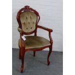 A contemporary stained wood open armchair with carved top rail over upholstered button back, arms