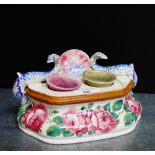 A Scottish Pottery Wemyss style inkwell painted with cabbage roses and dolphin surmounts, it has