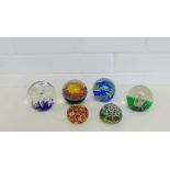 A collection of six paperweights to include three Caithness with pattern names 'Impulse', '