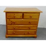 A pine chest, the rectangular top over two short and three long drawer, on bun feet, 80 x 94cm