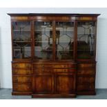 A large mahogany breakfront library bookcase, the cornice top above four astragal glazed doors