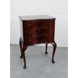 A mahogany serpentine chest of small proportions, with three long drawers and cabriole supports,