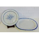 Creamware feather edged blue and white circular charger, (has a crack), with a floral spray to