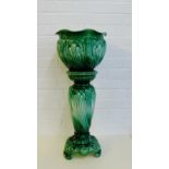 A Majolica green glazed Tudor jardiniere planter and stand, (2)