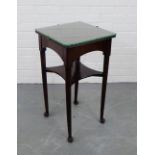 A mahogany two tier side table on tapering supports and pad feet, 70 x 38cm