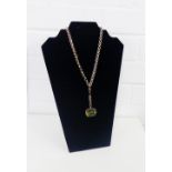 9 carat gold framed revolving citrine fob, hung on a gold chain stamped 9ct with two rolled gold