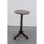 A mahogany occasional table, the circular dished top on a spiral twist column and tripod supports,