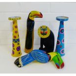 A pair of painted tin candlesticks, two toucans and a hard wooden cat figure, tallest, 30cm, (5)