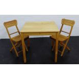 A small dining set comprising a pine square top table and two fold away chairs, 76 x 76cm (3)