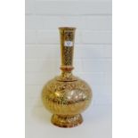 An Eastern copper lustre bottle necked vase on a circular foot rim, 43cm high