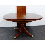 A contemporary mahogany dining table with extra leaf, 78 x 136cm
