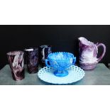 An amethyst slag glass moulded jug, together with three glass beakers, a blue and white moulded twin