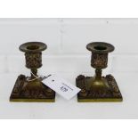 A pair of bronze dwarf desk candlesticks on square plinth bases, 9cm high, (2)