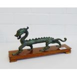 A bronze Dragon on hardwood stand, 30cm long